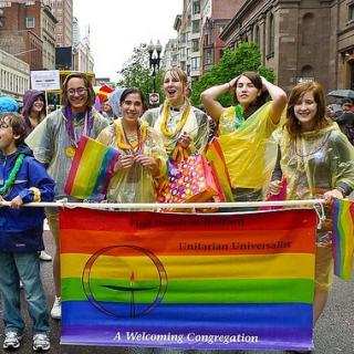 Youth from Bedford, MA march in Boston Pride parade and carry welcoming congregation flag.