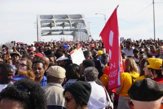 A crowd including many Unitarian Universalists crosses the Edmund Pettus Bridge in Selma, Alabama in March 2015.