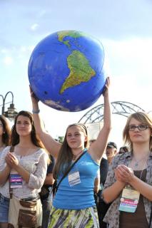 Girl holds up plastic earth ball at Environment Rally in March, 2014.