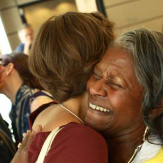 Two women hugging at General Assembly.