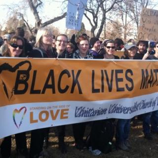 UUs holding Black Lives Matter banner witness for racial justice in Denver, CO, January 2015.