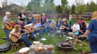 Multigenerational guitar circle.