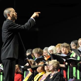A conductor leads choir at the UUA General Assembly.