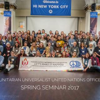 Group picture of participants at the 2017 Spring Seminar with a sign reading "Imagine a world without nuclear weapons - let's make it happen! Unitarian Universalists United for Peace and Planet"