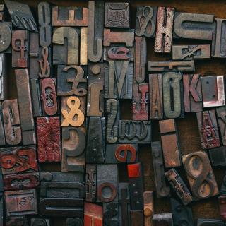 A collection of loose pieces of moveable type, in many shapes and sizes and from many different fonts. 