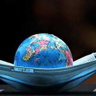 A globe sitting inside a boat-shaped mask
