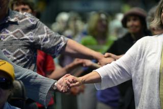 People holding hands in worship